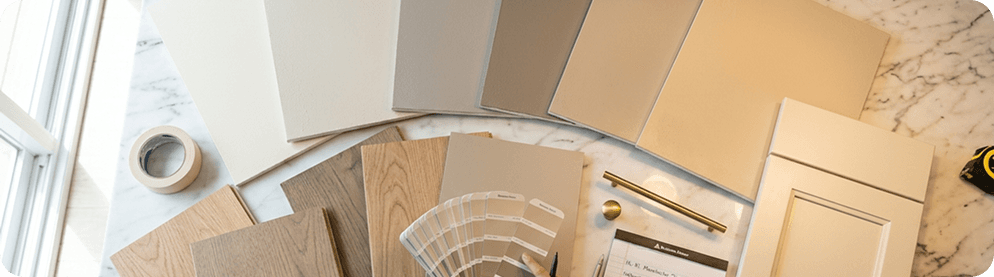 A homeowner reviewing paint color samples on an interior wall.