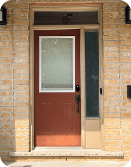 Close-up of the faded red front door before painting.
