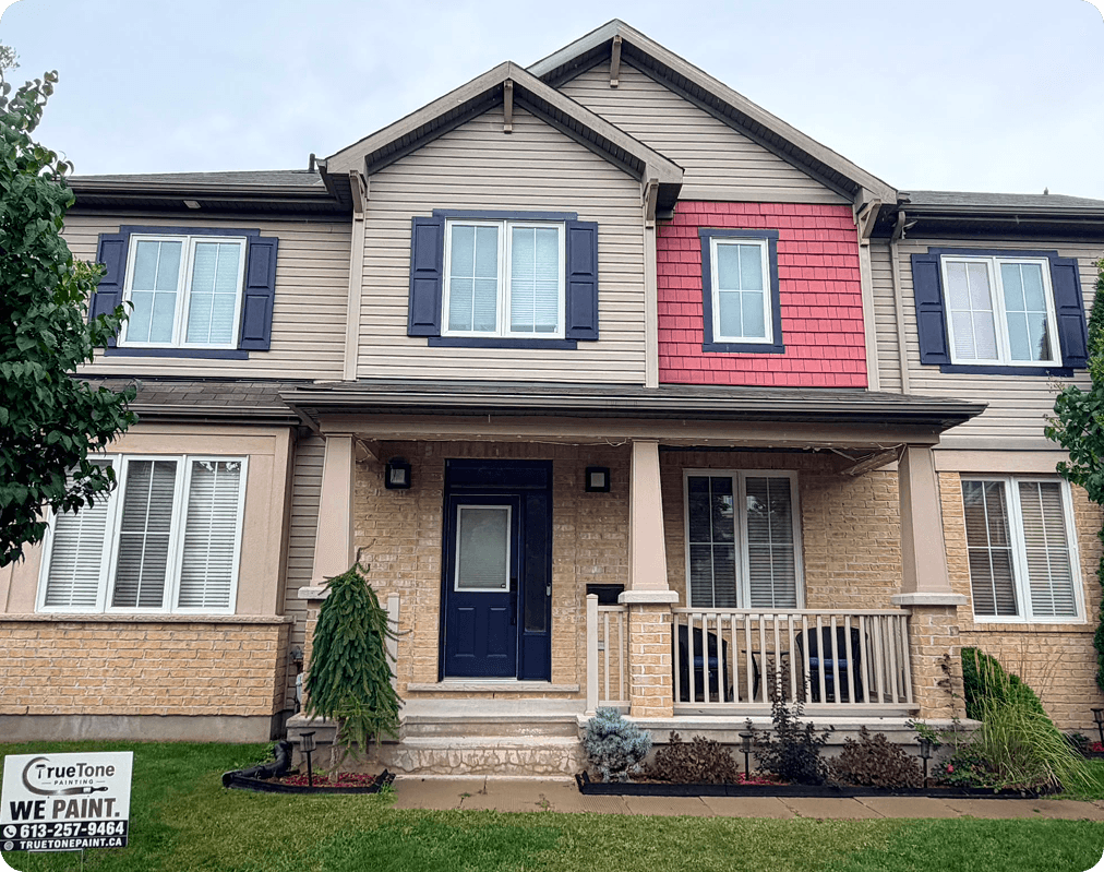 A wide view of the transformed home showing the navy door and shutters.