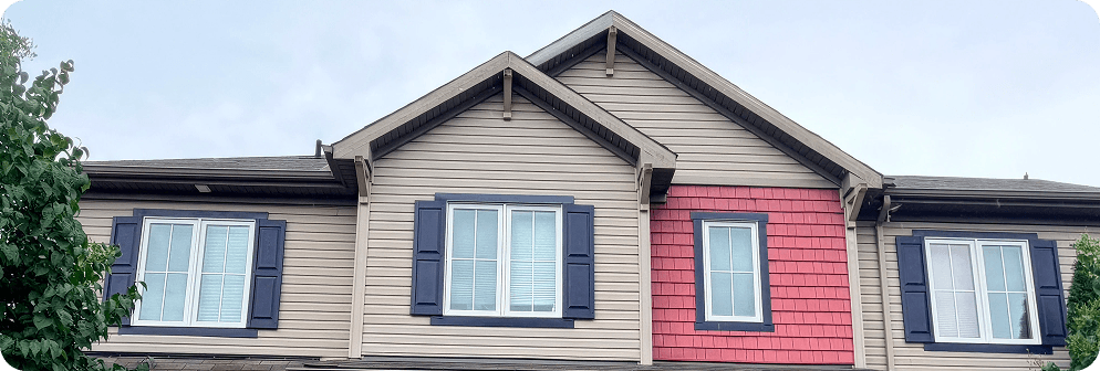 A brick and siding home after a curb appeal transformation with a navy front door.